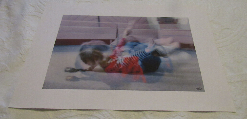 2008 Mark Panza Photo, “child tumbling on floor”; 13″ X 19″, over-exposed