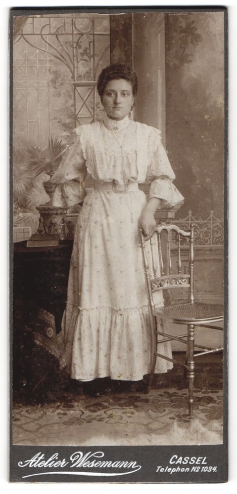 Photography studio Wesemann, Cassel, lady in elegant dress next to a chair
