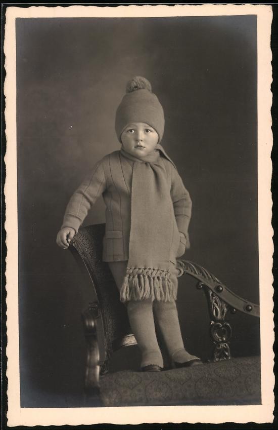Photograph by Billström, Kiel, showing a toddler in winter clothing…