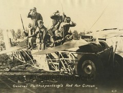 Red Air Circus mock airplane fight with masks bows arrows strange antique photo