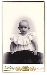 Photograph Sjöberg, Malmö, small child in white robe with attentive eye