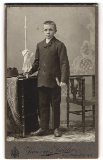 Photograph Jean van Daalen, Aalen, Bahnhofstrasse, boy in suit with book and