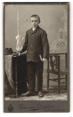 Photograph Jean van Daalen, Aalen, Bahnhofstrasse, boy in suit with book and